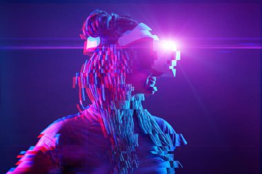 Woman is using virtual reality headset. Neon light studio portrait. Image with glitch effect.