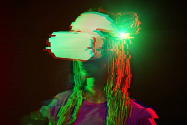 Woman is using virtual reality headset. Neon light studio portrait. Image with glitch effect.