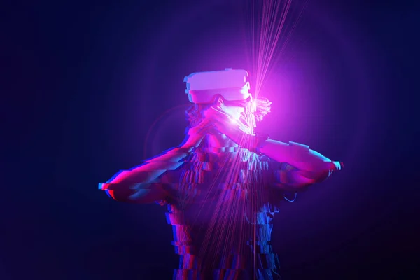 Woman is using virtual reality headset. Neon light studio portrait. Image with glitch effect. — Stok fotoğraf