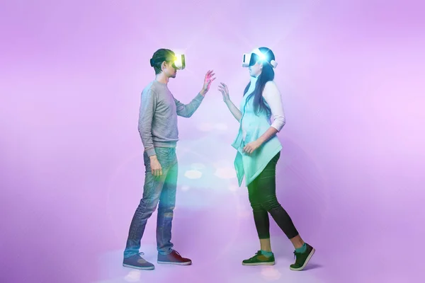 Pareja enamorada comunicarse usando un auricular de realidad virtual . — Foto de Stock