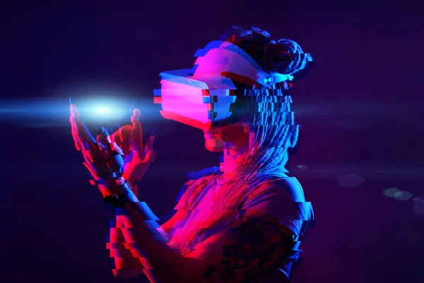 Woman is using virtual reality headset. Neon light studio portrait. Image with glitch effect. — Stock Fotó