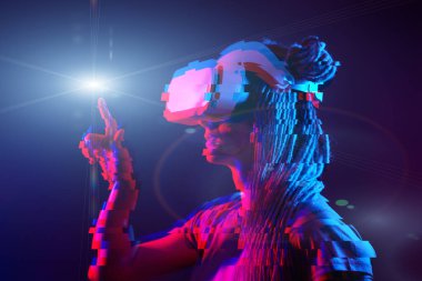 Woman is using virtual reality headset. Neon light studio portrait. Image with glitch effect.