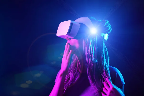 A mulher está usando fones de ouvido de realidade virtual. Retrato de estúdio luz néon. — Fotografia de Stock