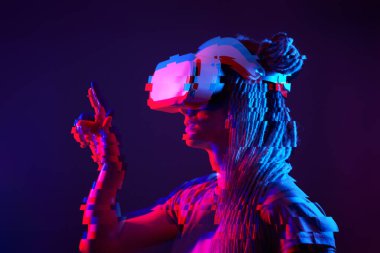 Woman is using virtual reality headset. Neon light studio portrait. Image with glitch effect.