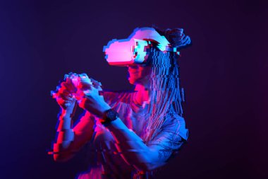 Woman is using virtual reality headset. Neon light studio portrait. Image with glitch effect.