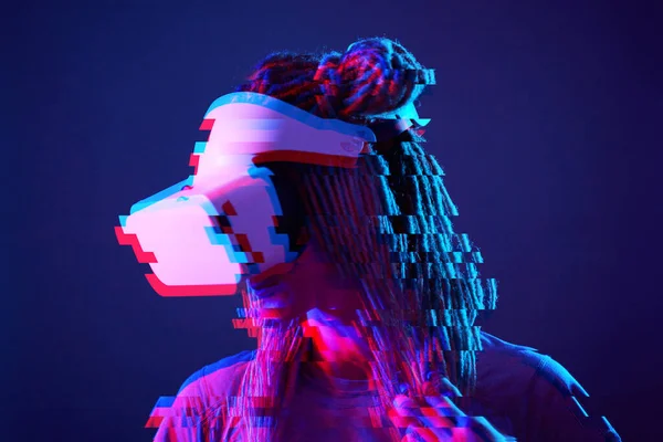 Woman is using virtual reality headset. Neon light studio portrait. Image with glitch effect. — Φωτογραφία Αρχείου