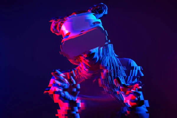 Woman is using virtual reality headset. Neon light studio portrait. Image with glitch effect. — Φωτογραφία Αρχείου