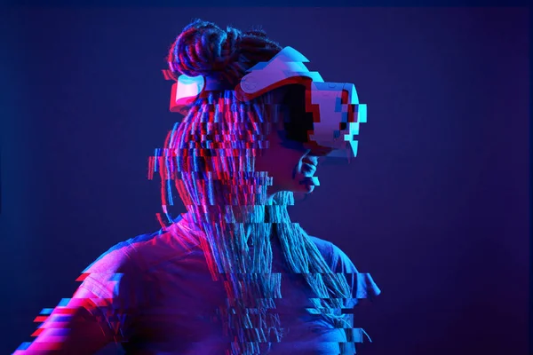 Woman is using virtual reality headset. Neon light studio portrait. Image with glitch effect. — Φωτογραφία Αρχείου