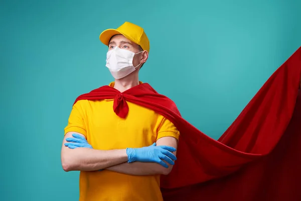 Courier is wearing in superhero cloak and protected face mask. — Stock Photo, Image