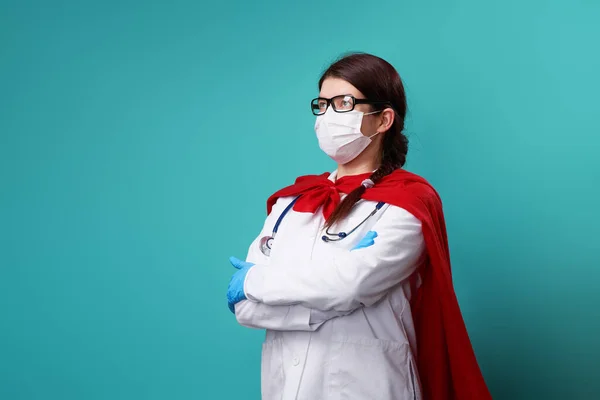 Süper kahraman peleriniyle cerrahi maske takan bir doktor.. — Stok fotoğraf