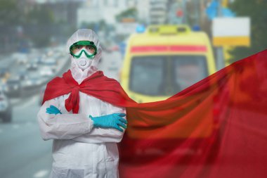 Doktor PPE giyiyor - kostüm, eldivenler ve süper kahraman maskesi takıyor..