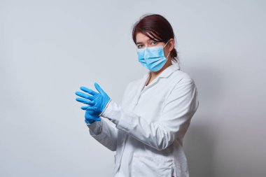 Doktor ameliyat maskesi ve eldiven takıyor..
