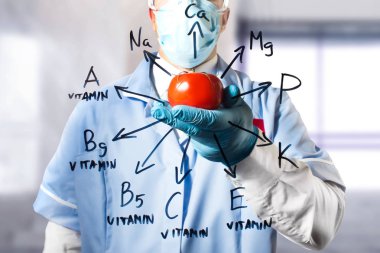 Domates sebze içinde tam vücut ile çizilmiş vitamin ve mineral cam diyagramda kıyafeti ve lastik eldiven tutarak bir asistan fotoğrafı.