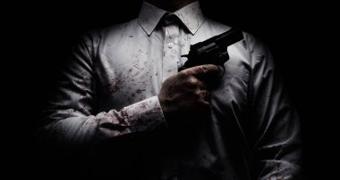 Horror scary photo of a killer in white shirt with blood splatter and posing with black gun on dark background. clipart