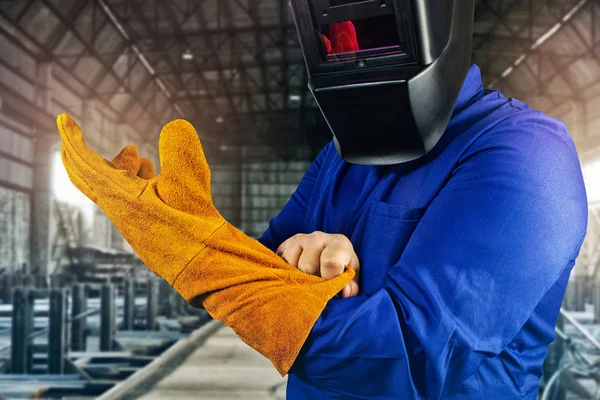 Welder worker pulling on orange gloves close-up view. — Stock Photo, Image