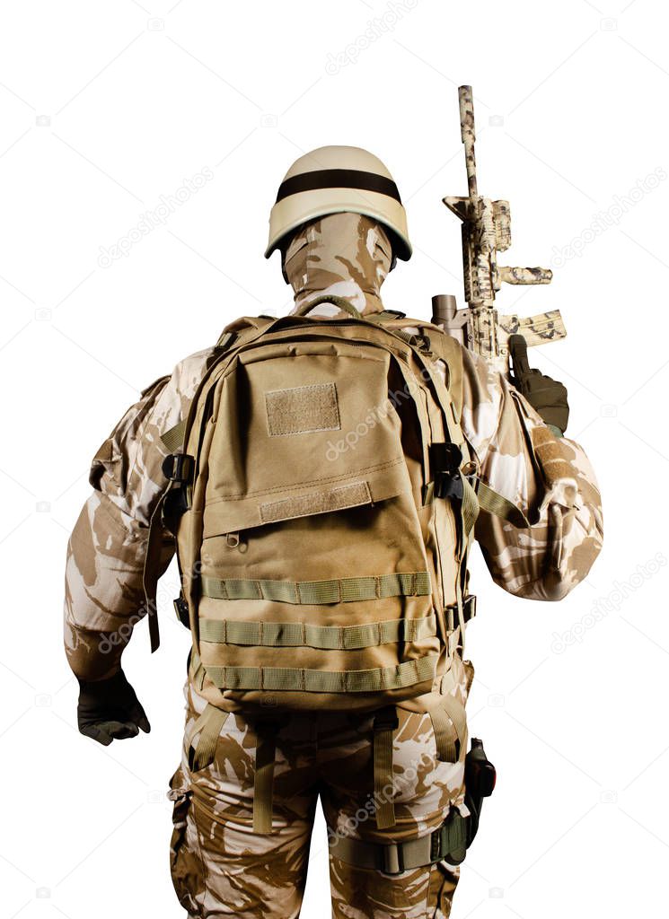 Isolated soldier in uniform standing fully equipped rear view.