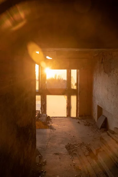 Abandoned building. Ghost city. Sunrise through window