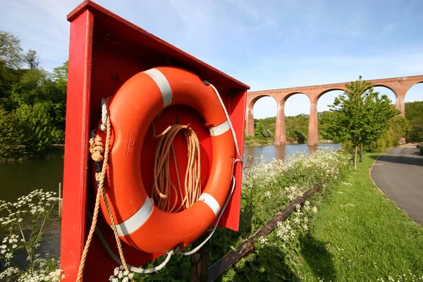 Life saving ring with attahed rope on the bank of the River Esk, north Yorkshire.