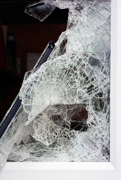 Shattered safety glass in window after attack by burglars.