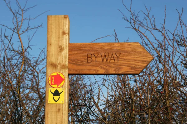 Wooden post and sign designating public right of way for walkers and ramblers,