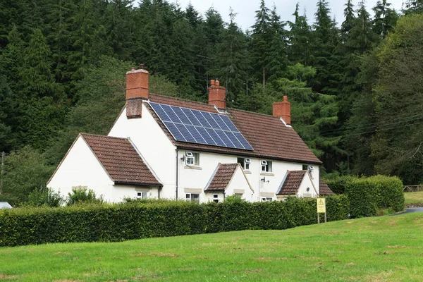 Country cottages with one fitted with solar panels on the roof. Yorkshire. UK.