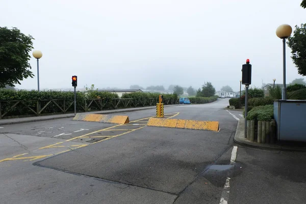 Road barriers to control ingress and egress of road traffic at a coastal holiday site. Operated by code numbre or issued security card.