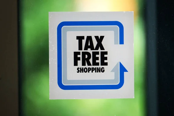 Tax free shopping sign on airport shop doorway.