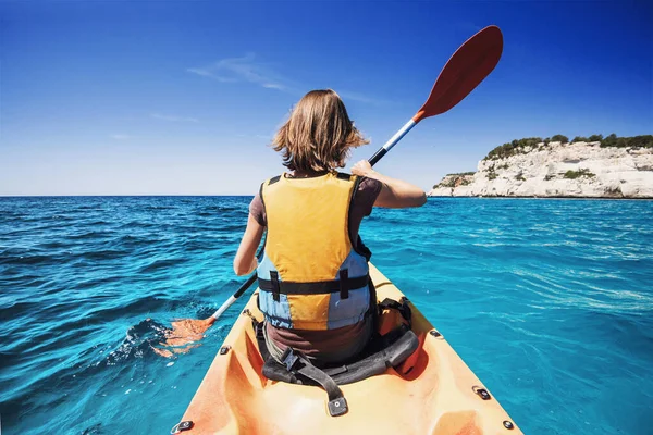 Young woman kayaking in the sea. Active lifestyle and travel concept