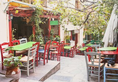 Yunanistan 'ın başkenti Atina' nın eski Plaka semtinde, arka planda güzel Akdeniz caddesi, Charming caddesi bulunan geleneksel Yunan kafesi
