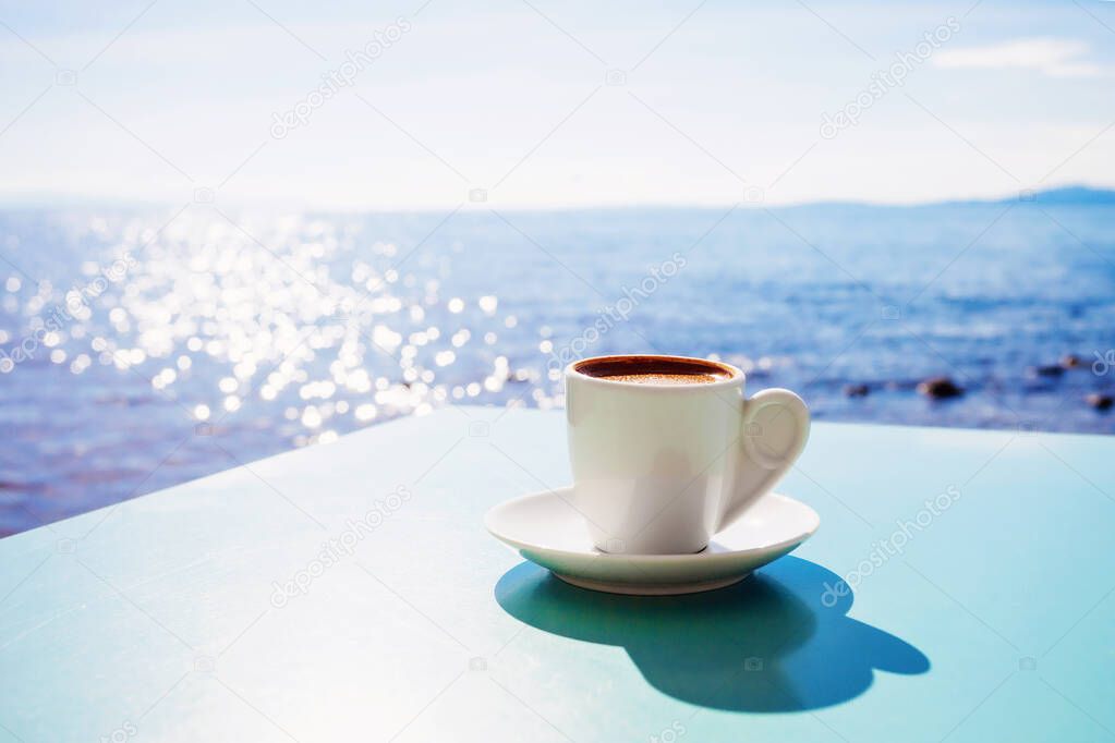 Traditional greek coffee in cafe with thr sea at the background