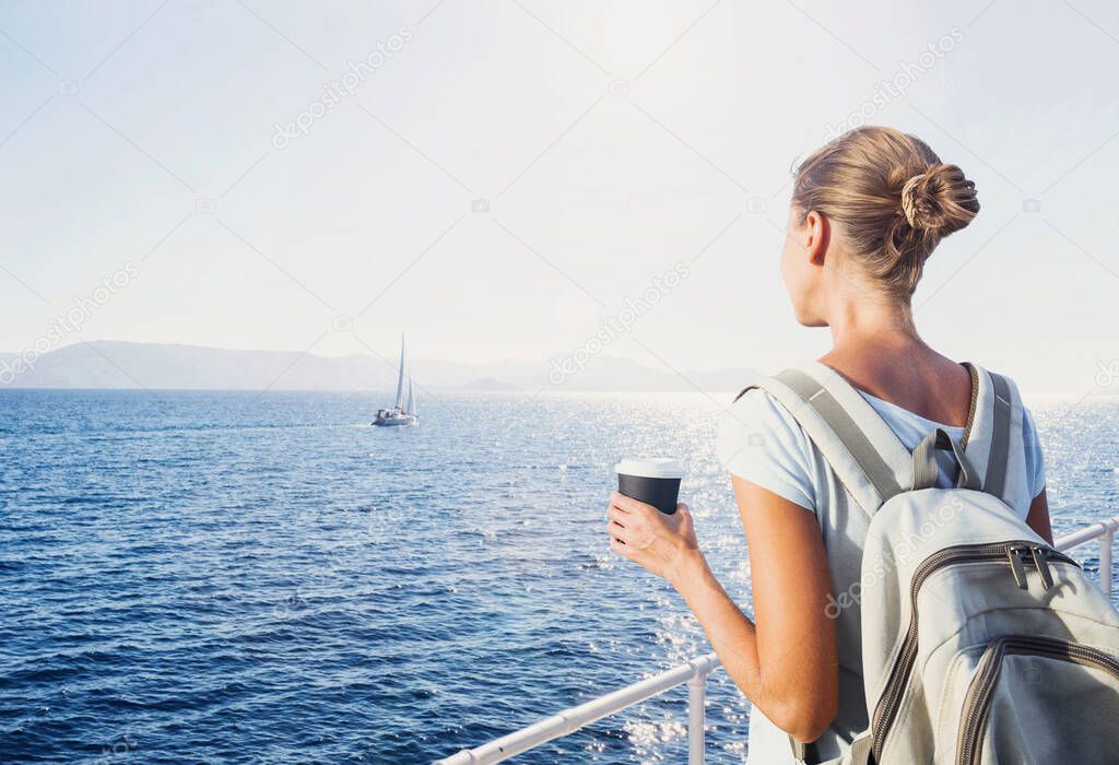 Traveller woman standing on ferry boat, looking at sea and holding coffee cup, travel and active lifestyle concept