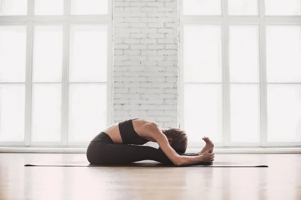 Young woman meditating. Girl practicing yoga in class. Relaxation, body care, meditation,balance, harmony, recreation concept