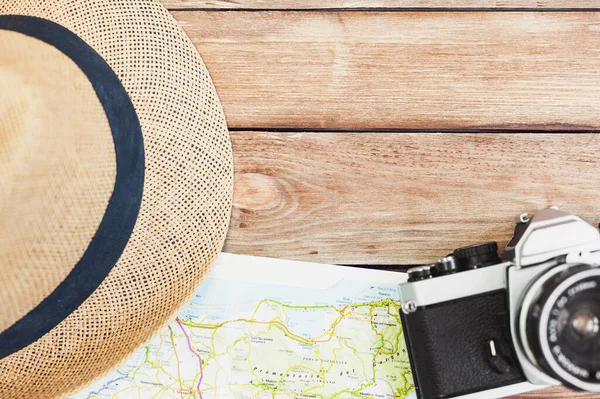 Accessories for travel. photo camera,  travel map and hat. Top view. Holidays and tourism concept