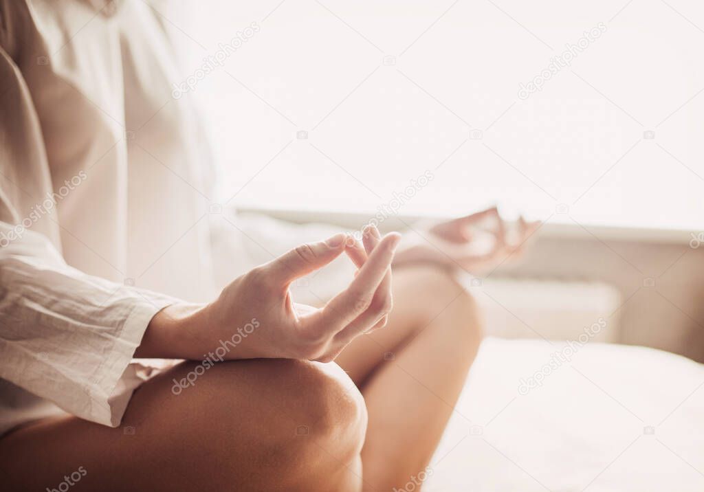 Woman meditating at home. Girl practicing yoga in yoga class