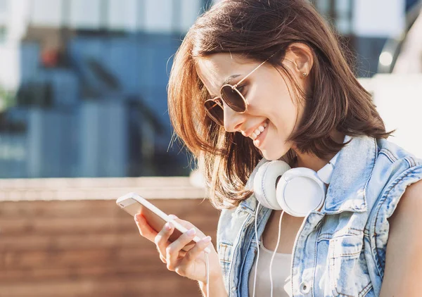 Jong Meisje Met Koptelefoon Met Behulp Van Smartphone Buiten — Stockfoto