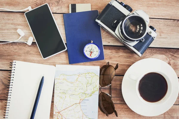 Accessories for travel. photo camera,  travel map, compass, smartphone, cup, sunglasses. Top view. Holidays and tourism concept