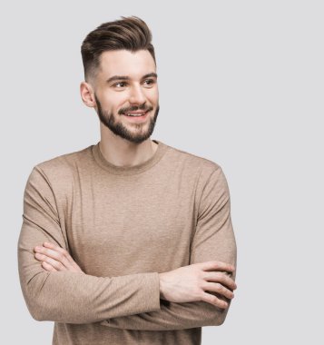 Handsome smiling young man isolated on gray background closeup portrait. Laughing joyful cheerful men studio shot clipart
