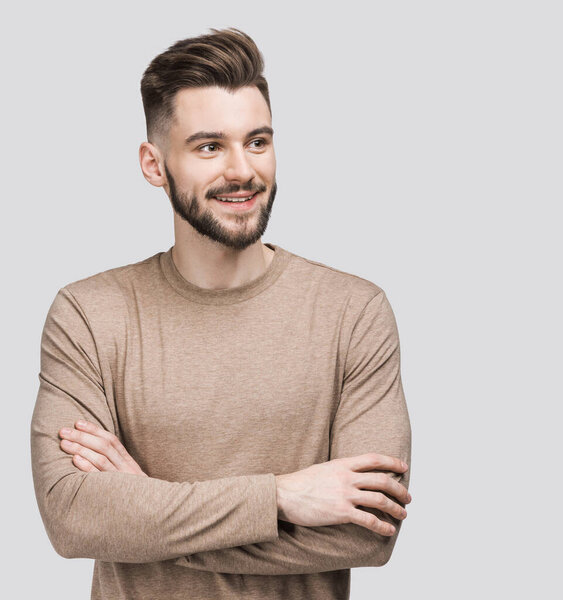 Handsome smiling young man isolated on gray background closeup portrait. Laughing joyful cheerful men studio shot