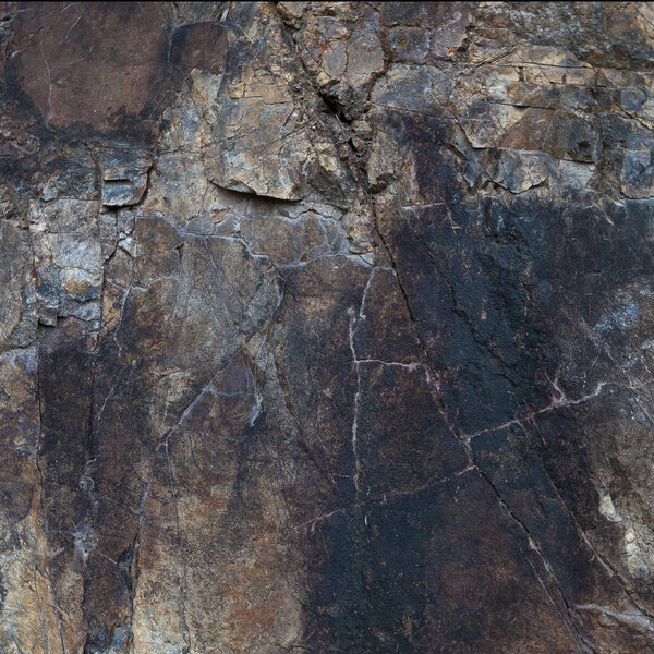 Fragment of granite rocks with large cracks