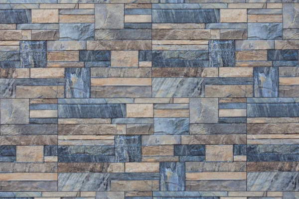 Wall from pieces of blue and beige marble