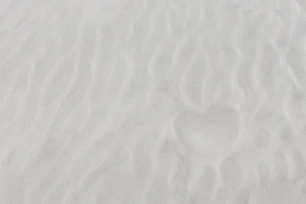 Shape of heart on white sand — Stock Photo, Image