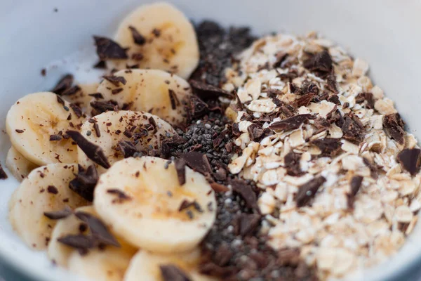 YOGURT BALL WITH BANANA OAT AND CHOCOLATE ON A WHITE BACKGROUND