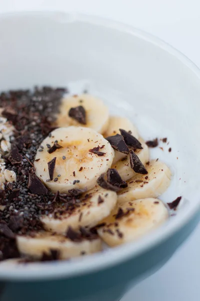 YOGURT BALL WITH BANANA OAT AND CHOCOLATE ON A WHITE BACKGROUND