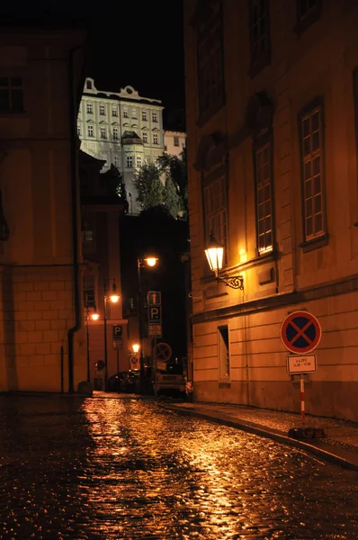 Summer night rain on the bridge of the historical part of Prague