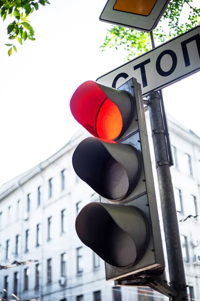 Red traffic light in the city center.