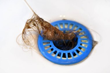 strainer in the sink clogged with hair, falling hair,hair in the sink wiped with a cotton swab clipart