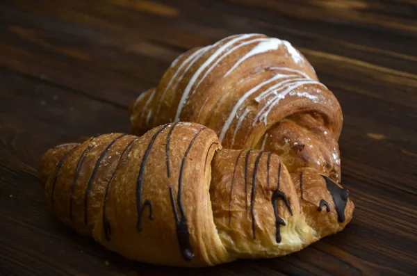 Croissant bakery on teak wood table — Stock Photo, Image