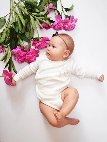 Peony with child. Free place for text. Happy baby girl with a pink flower — Stock Photo, Image