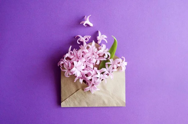 Tarjeta cuadrada vintage con cerca abierto sobre de papel artesanal lleno de flores de color lila púrpura flor de primavera. Vista superior, plano . — Foto de Stock