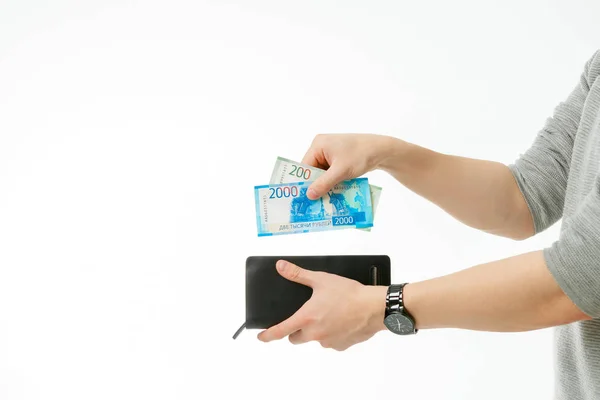 a man takes money from his wallet on an isolated white background